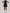 Person wearing a black sleeveless dress with a collar on a white background